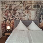Doppelbett vor Designtapete im Ferienappartement Typ A